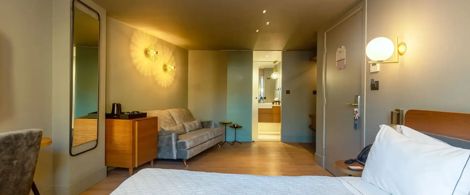 a bedroom with a bed and a couch