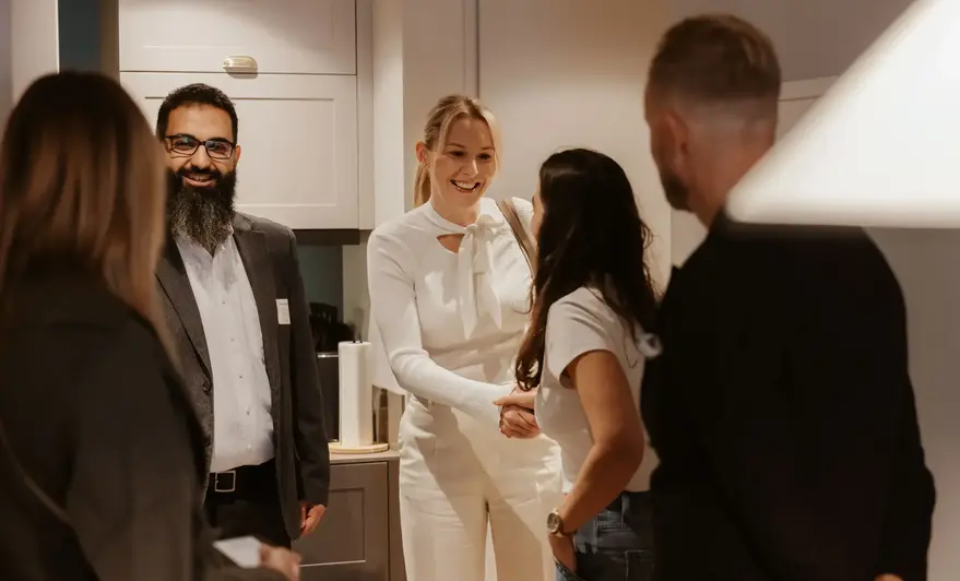 a woman shaking hands with a group of people