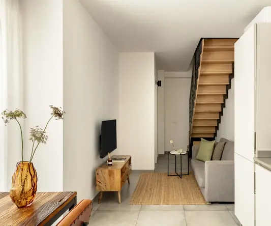 a living room with a staircase and a couch