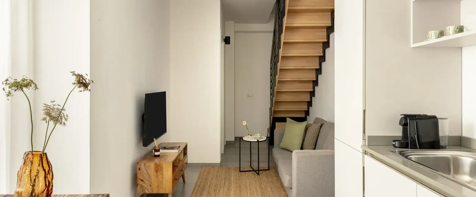a living room with a staircase and a couch