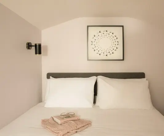 a bed with pillows and a book on it