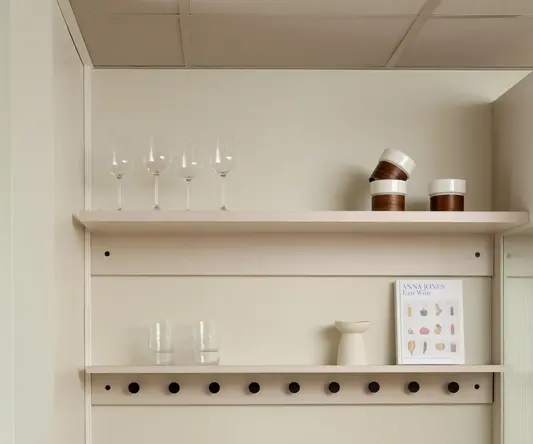 a kitchen counter with a couple of glasses and a plate of bread