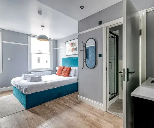 a bedroom with a bed and a mirror