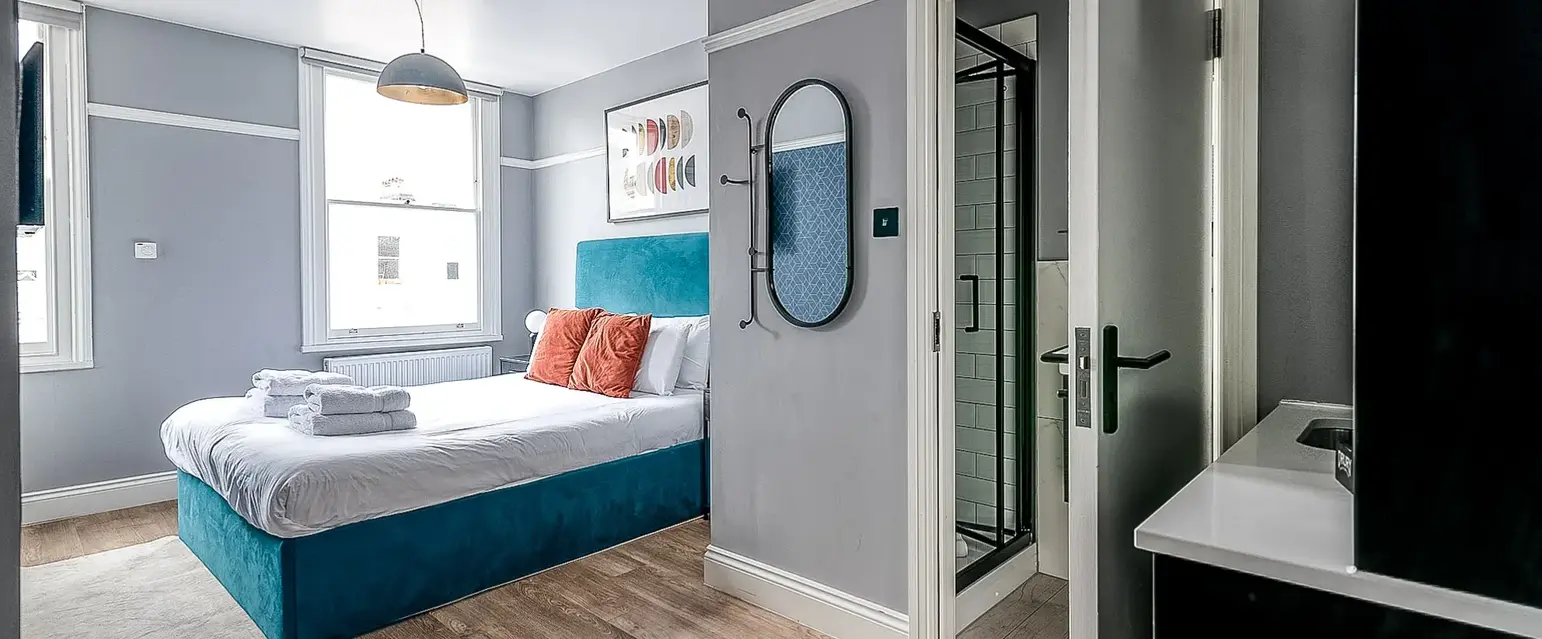 a bedroom with a bed and a mirror