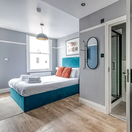 a bedroom with a bed and a mirror