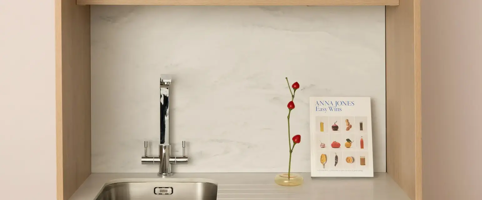 a sink and a book on a shelf