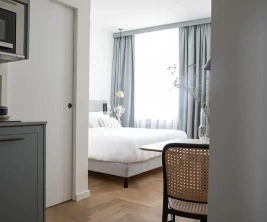 a bedroom with a bed and a table