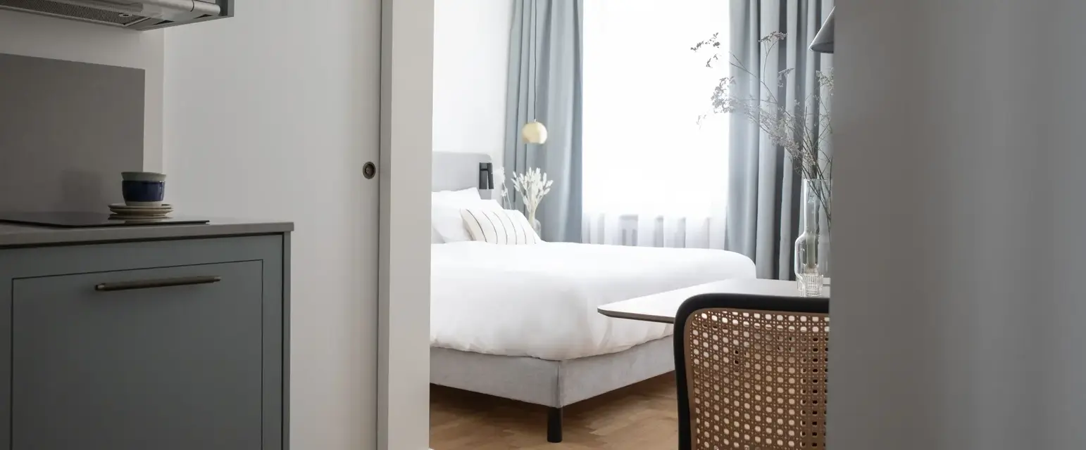 a bedroom with a bed and a table