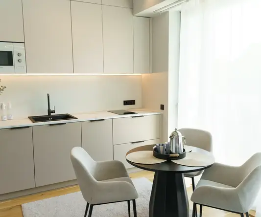 a kitchen with a table and chairs