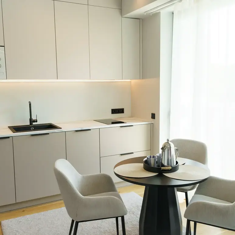 a kitchen with a table and chairs