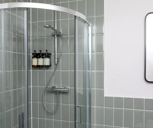 a shower with a shower head and a shower head
