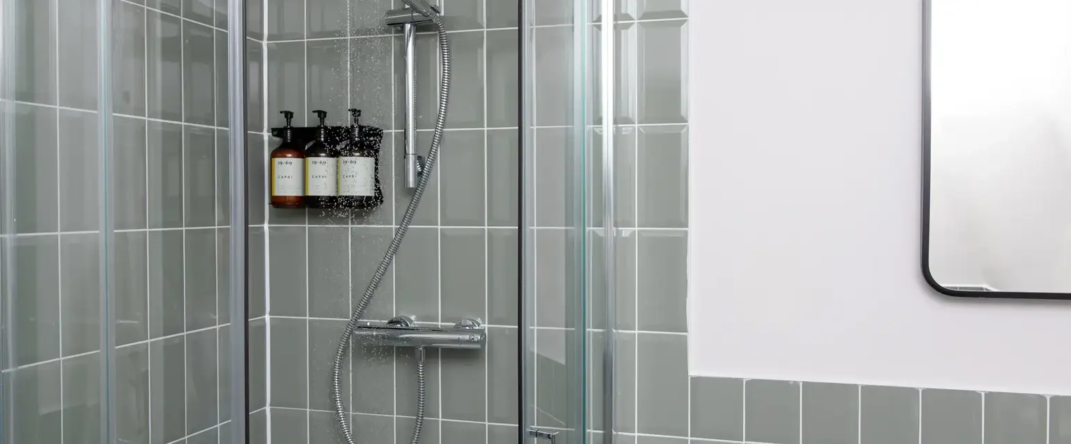 a shower with a shower head and a shower head