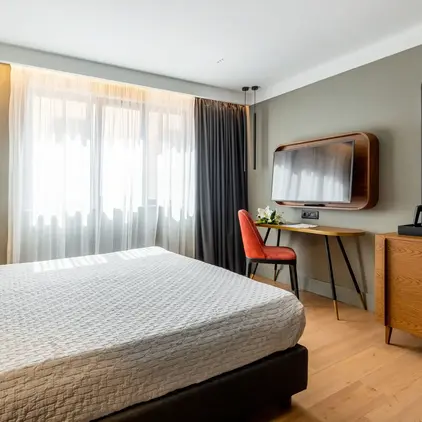 a room with a bed and a tv