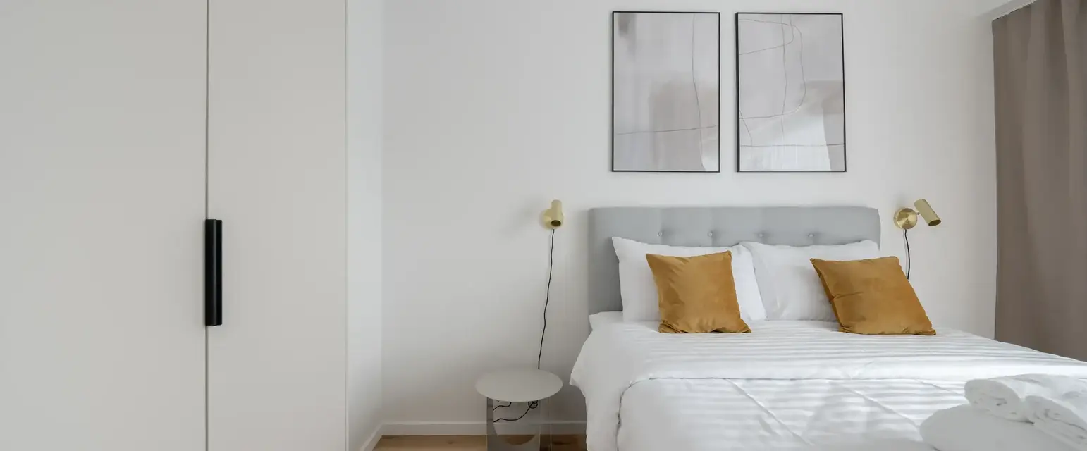 a bed with pillows and a lamp