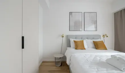 a bed with pillows and a lamp