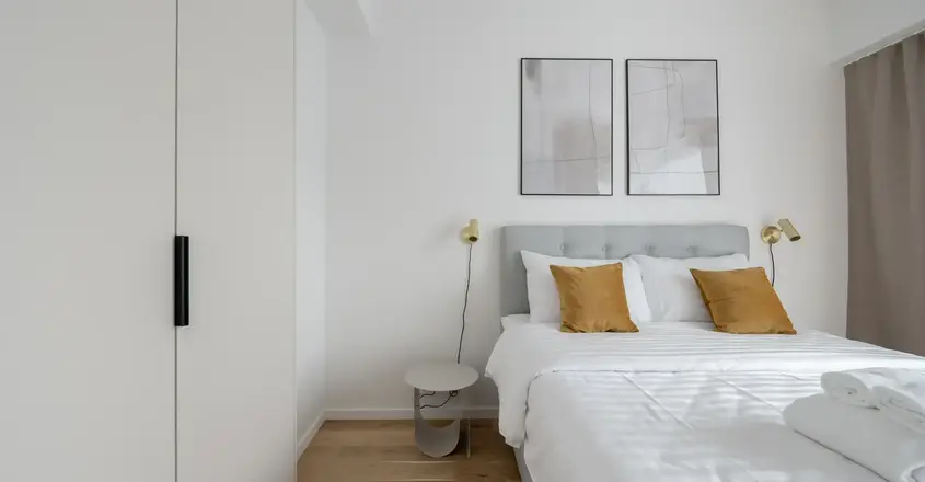 a bed with pillows and a lamp