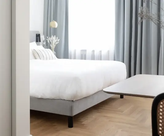 a bedroom with a bed and a table