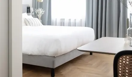 a bedroom with a bed and a table