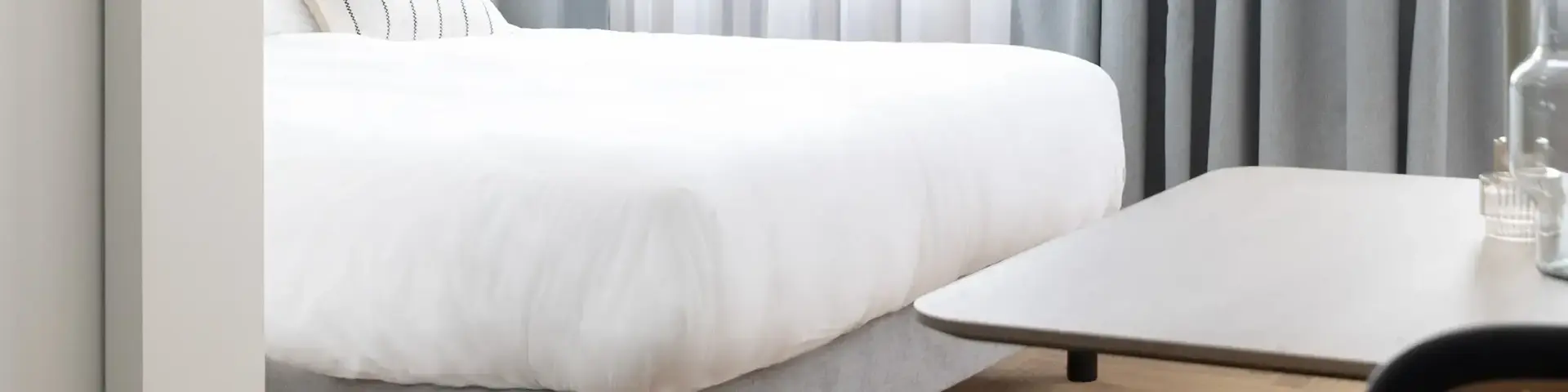 a bedroom with a bed and a table