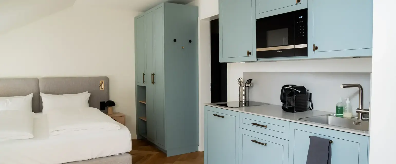 a bedroom with a bed and a microwave