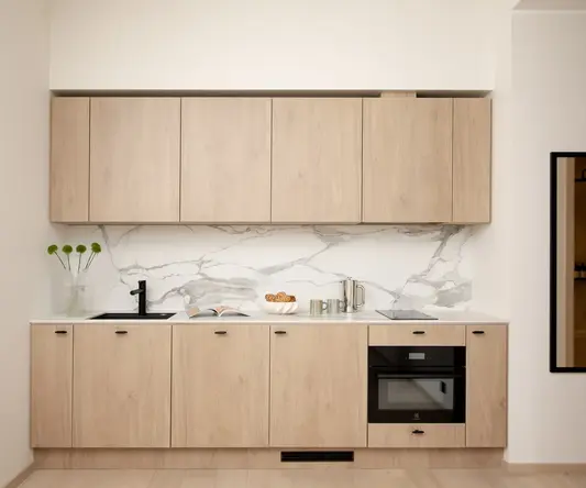 a kitchen with wood cabinets and a sink