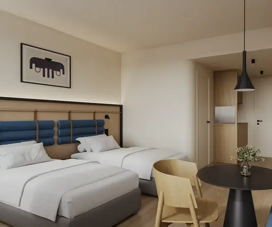 a room with two beds and a table