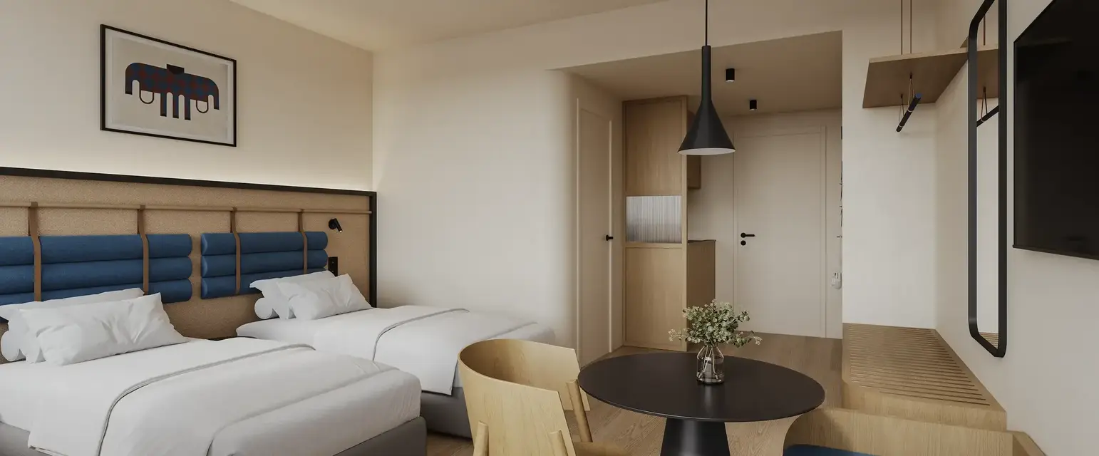 a room with two beds and a table