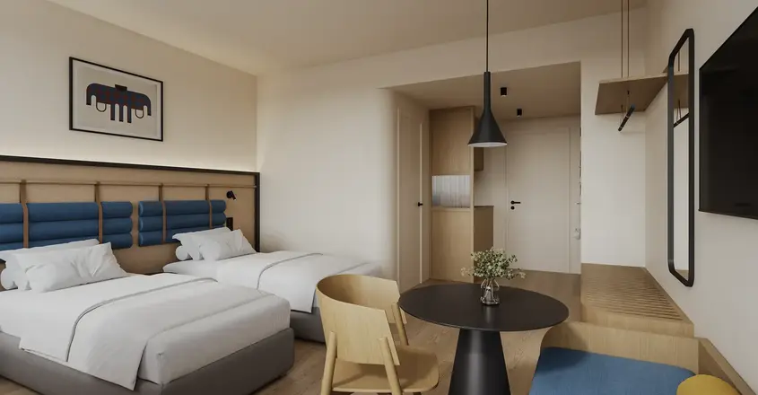 a room with two beds and a table