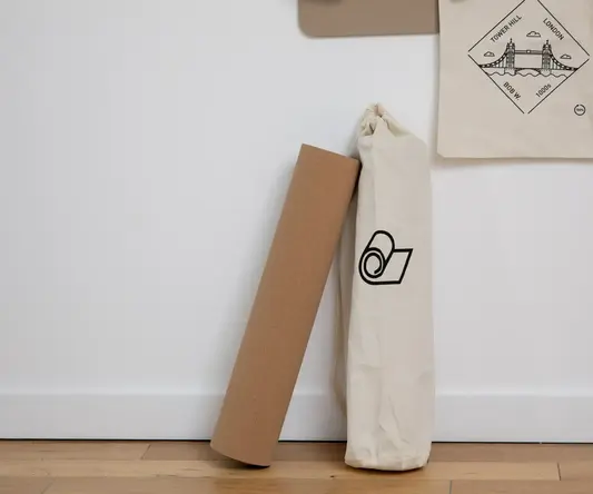 a roll of yoga mat next to a bag