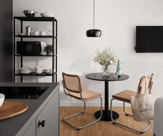 a kitchen with a table and chairs