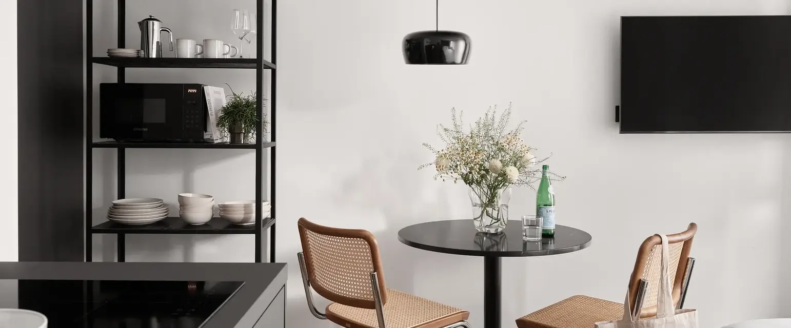 a kitchen with a table and chairs