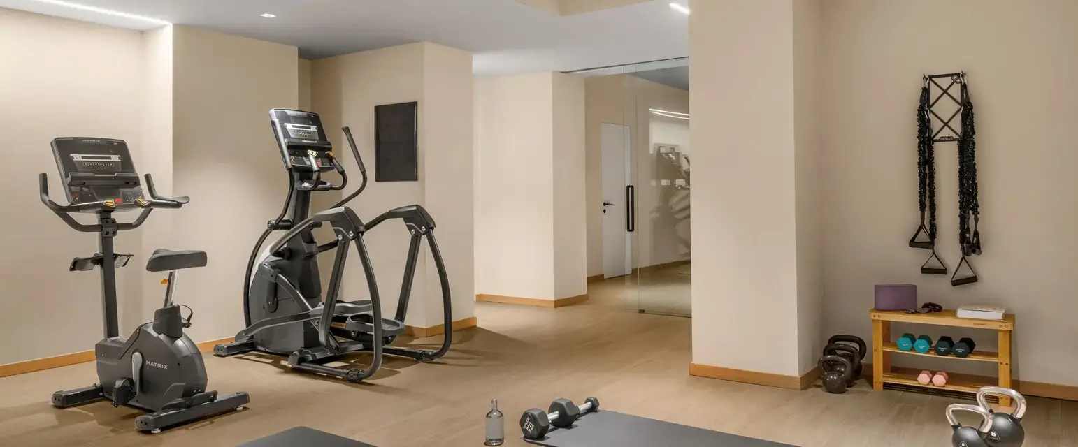 a room with exercise equipment and a mirror
