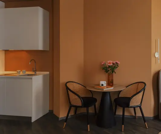 a room with a bed and a table and chairs