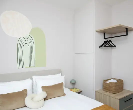 a bedroom with a bed and a shelf