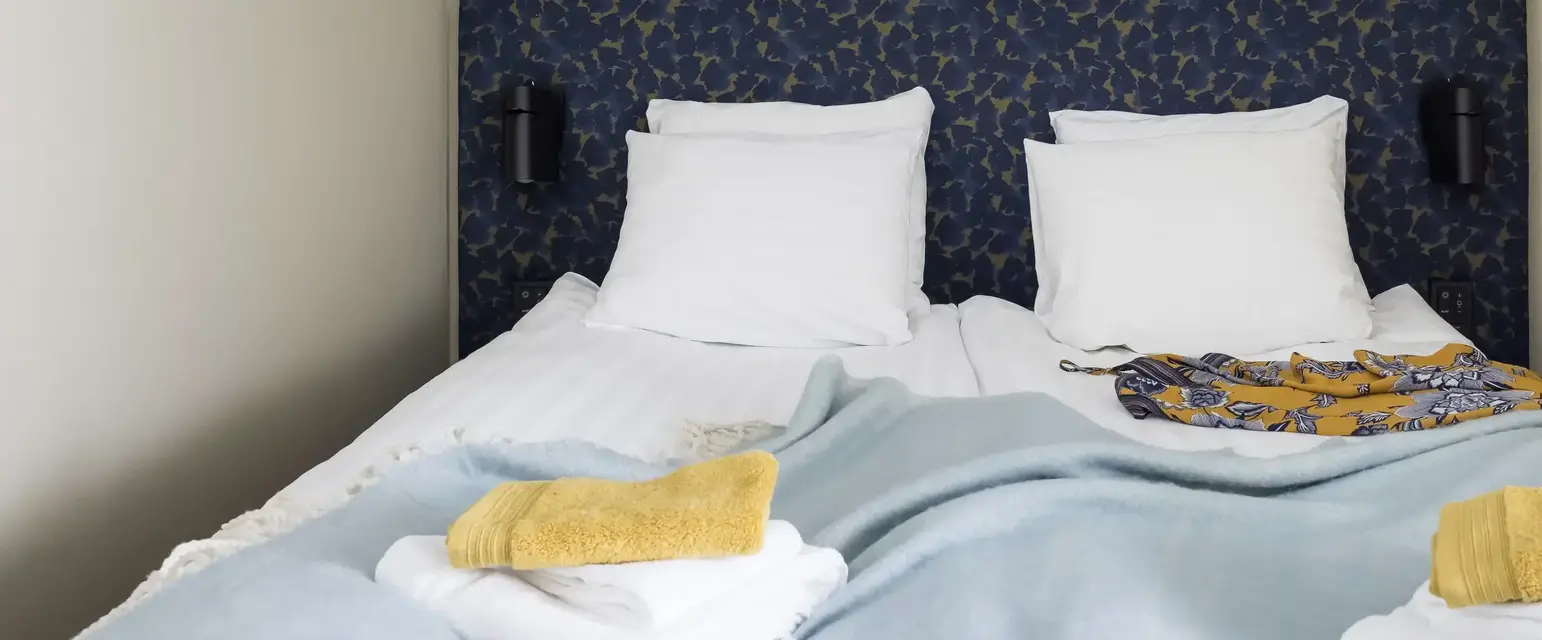 a bed with pillows and blankets