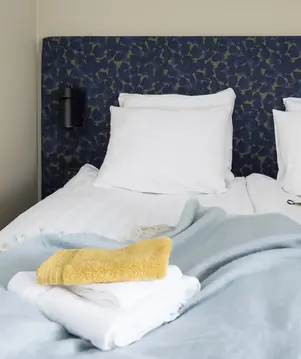 a bed with pillows and blankets