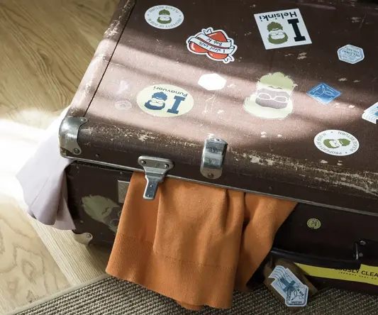 a suitcase with stickers on it
