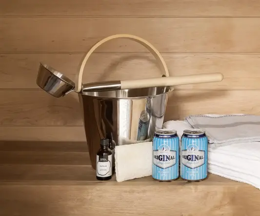 a bucket and cans of beer next to a bucket and towels