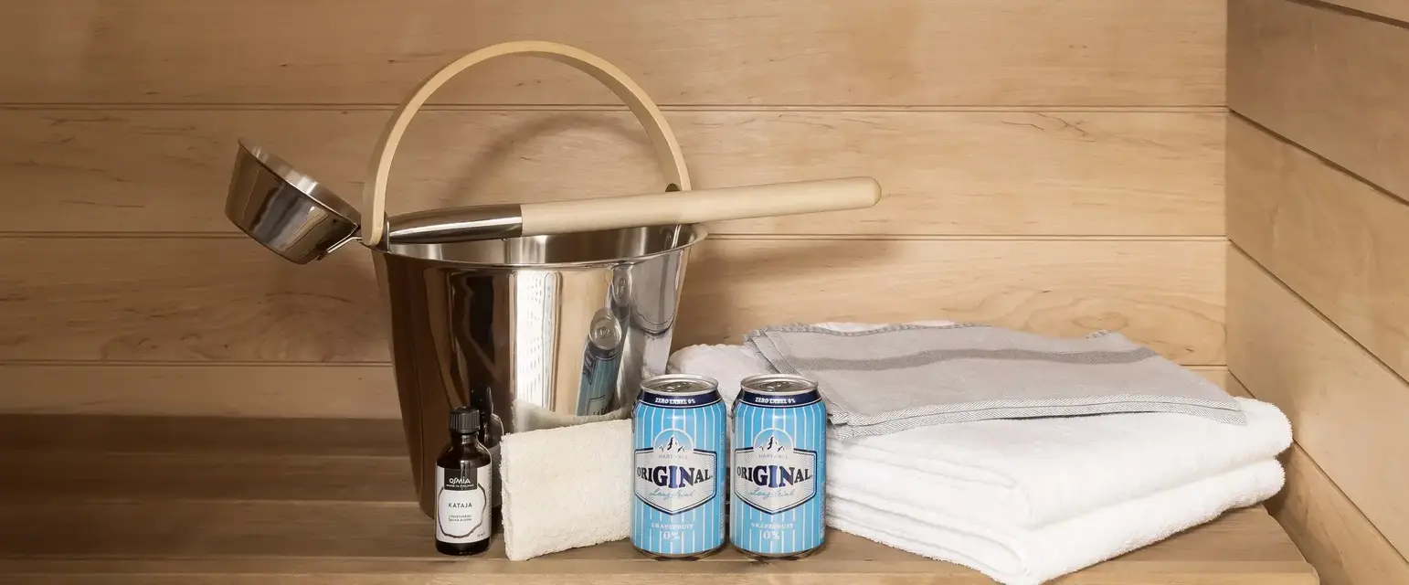 a bucket and cans of beer next to a bucket and towels