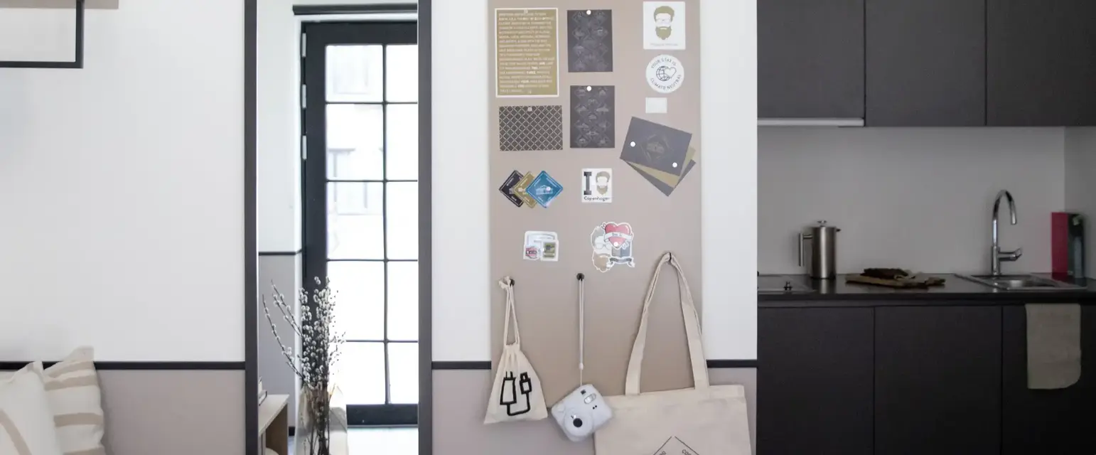 a wall with a mirror and a bulletin board