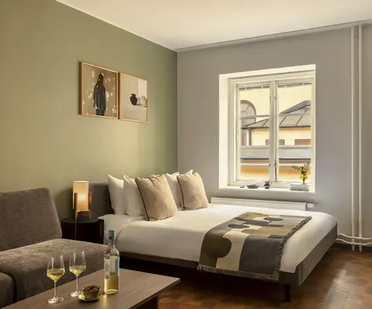 a bedroom with a bed and a couch