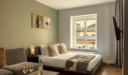 a bedroom with a bed and a couch