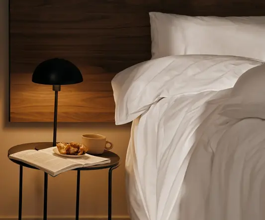 a table next to a bed