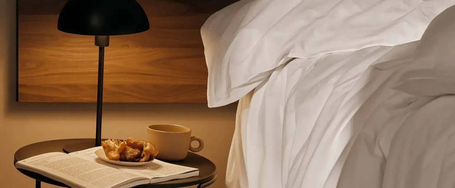 a table next to a bed