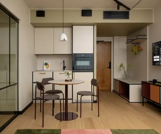a kitchen and dining area with a table and chairs