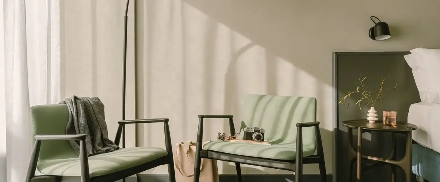 a room with green chairs and a lamp