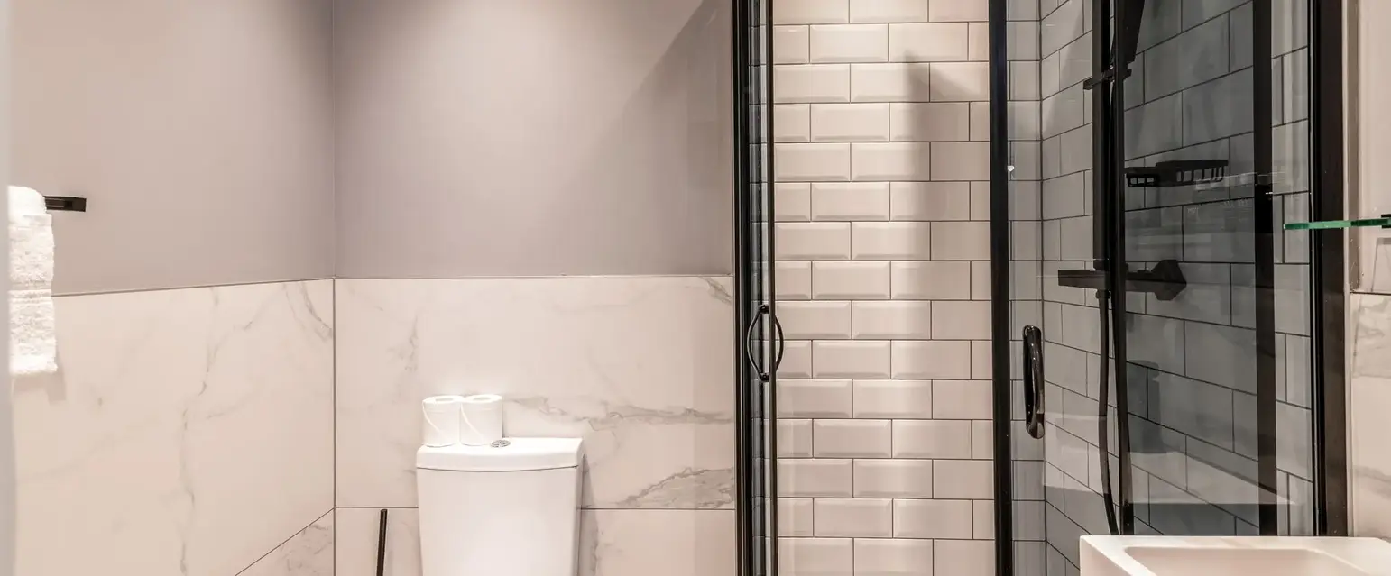 a bathroom with a toilet and shower