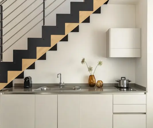 a kitchen with a sink and a pot on the counter