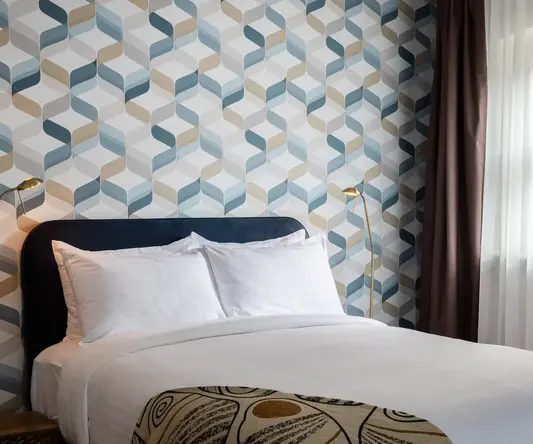 a bed with a lamp in a room