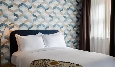 a bed with a lamp in a room